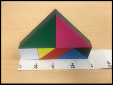 A tangram structure and some measuring tape indicating that it measures close to one quarter of a Zoomboogle.